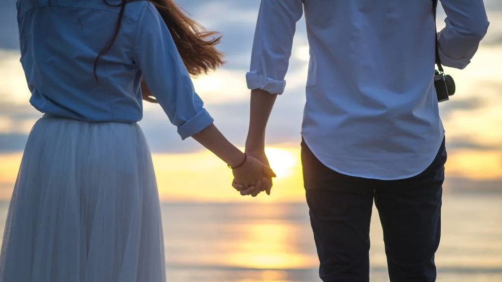 Holding hands on beach