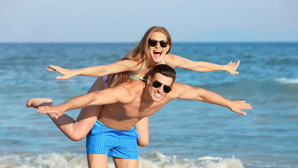 Playful beach date moment