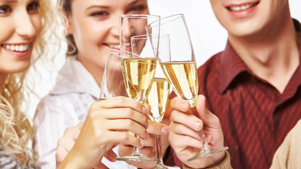 friends cheering with plastic champagne flutes