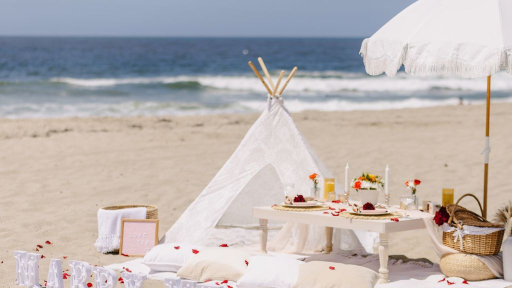 luxury beach picnic setup with white umbrella