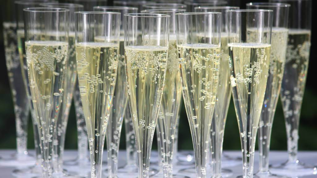 plastic champagne flutes filled with bubbly