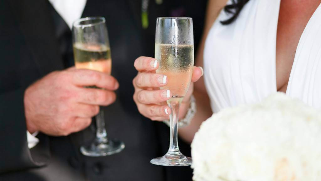 wedding toast with plastic champagne flutes