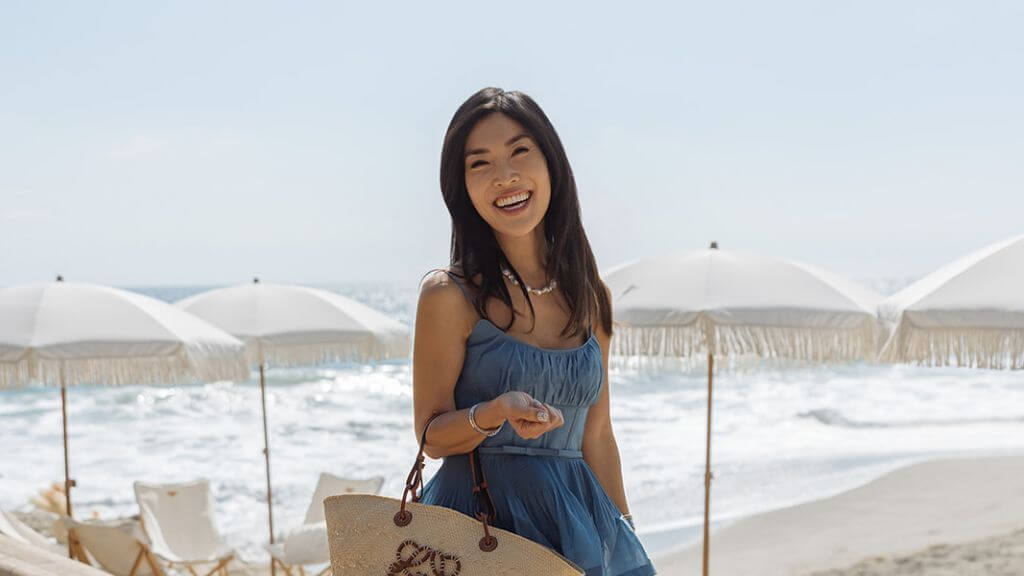 Blue Dress Beach Picnic Portrait Woman in a blue dress standing near a white beach picnic setup