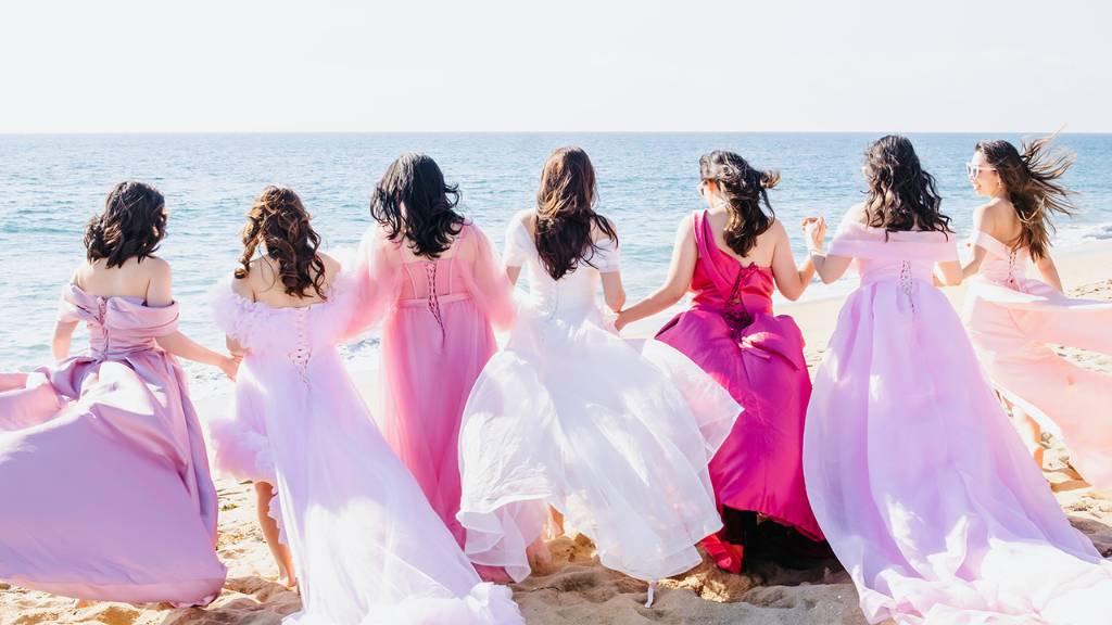 bridesmaids walking on beach