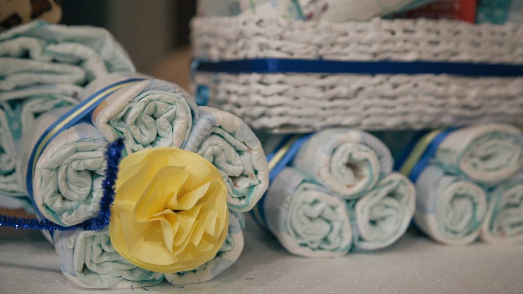 rolled diapers with ribbon and flower detail