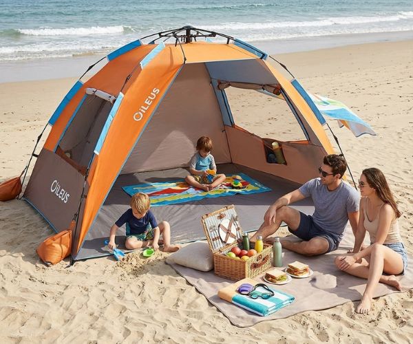 family using a beach half tent