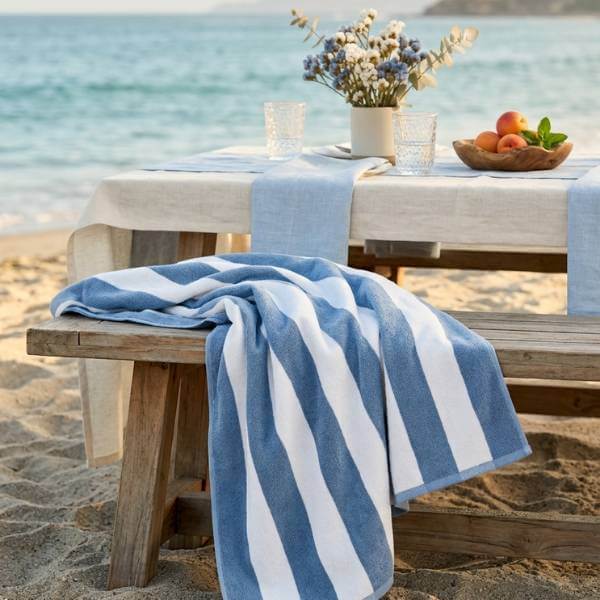 blue striped beach towel by picnic table