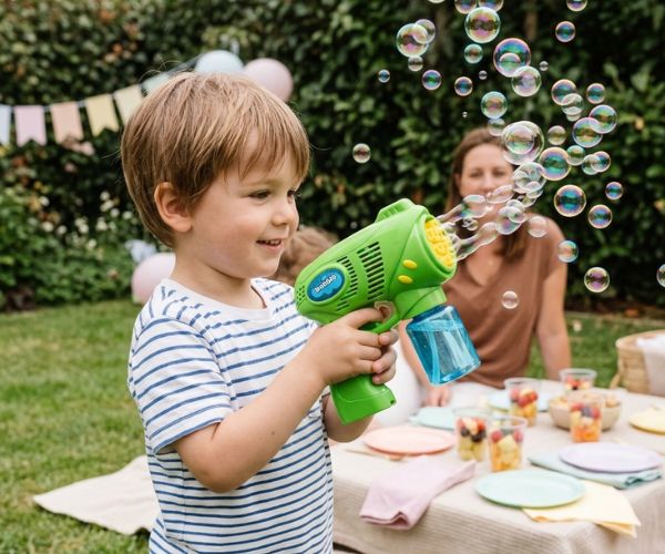 child using bubble gun