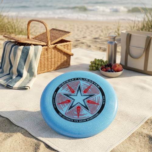 Discraft Sport Disc on a beach picnic blanket with outdoor picnic essentials