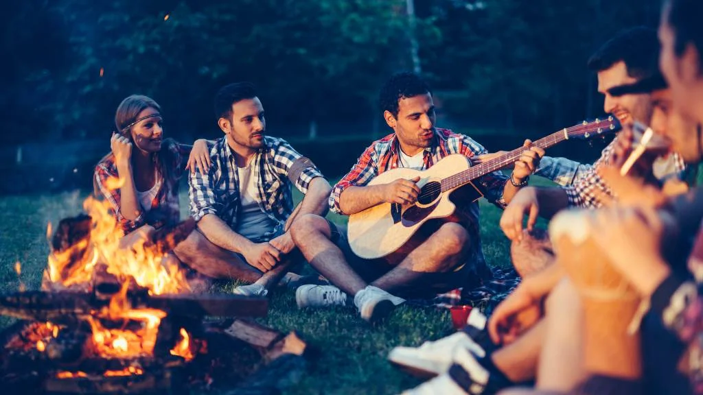 evening picnic with music by a fire