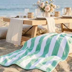 green striped beach towel at beach picnic