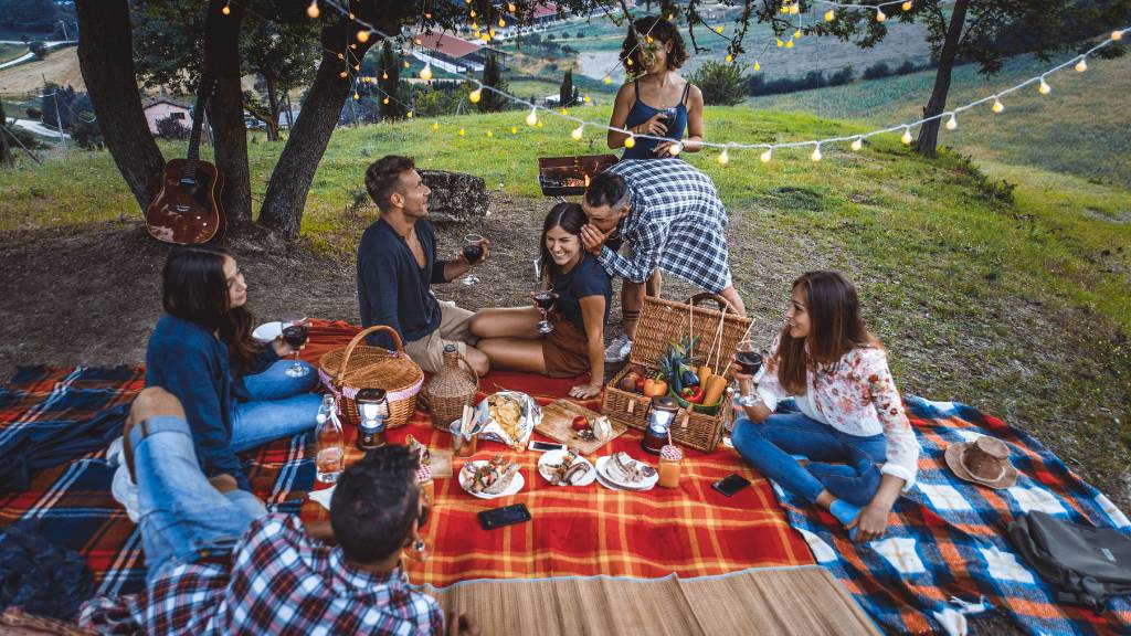 group picnic setup on grassy hillside