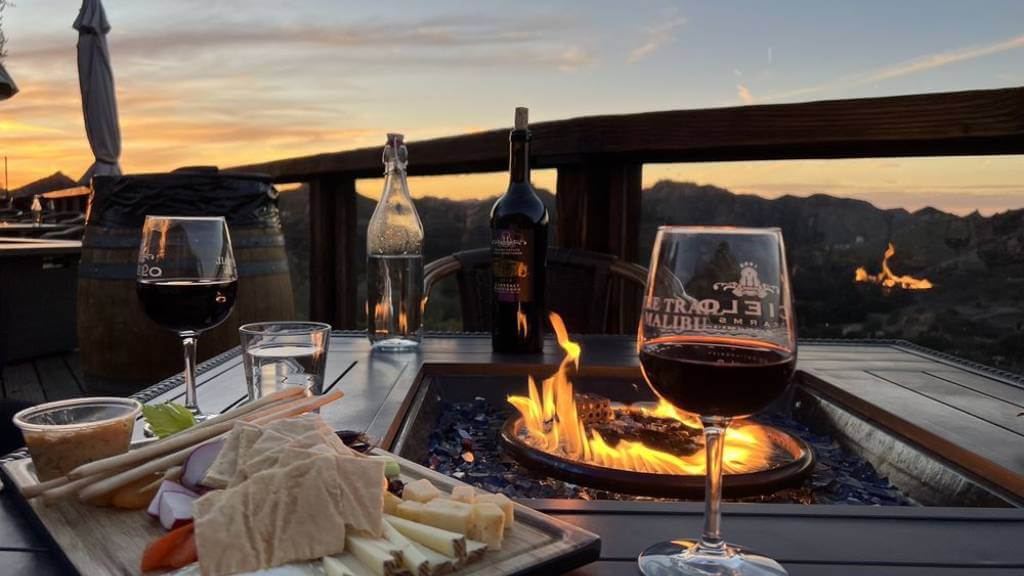 outdoor wine setup with sunset