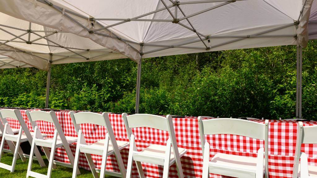 white 10x30 party tent with chairs outdoors