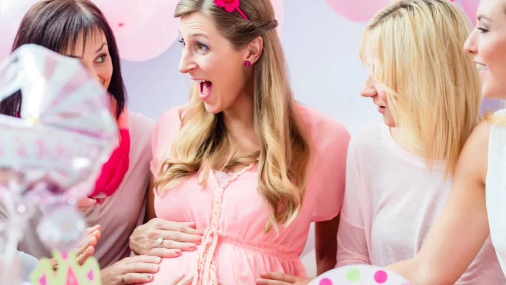 excited mom surrounded by baby shower guests