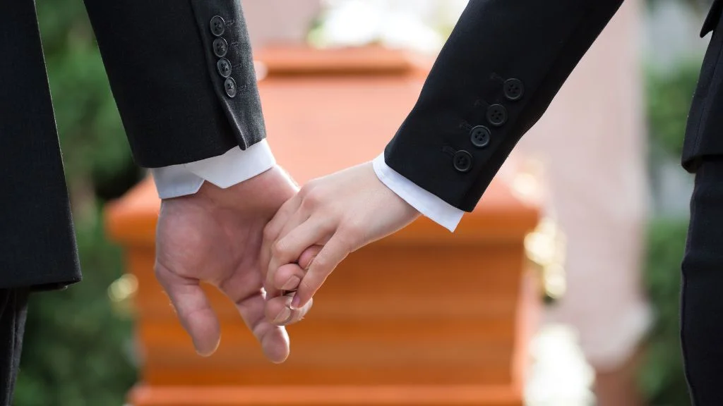 holding hands at a mock marriage funeral