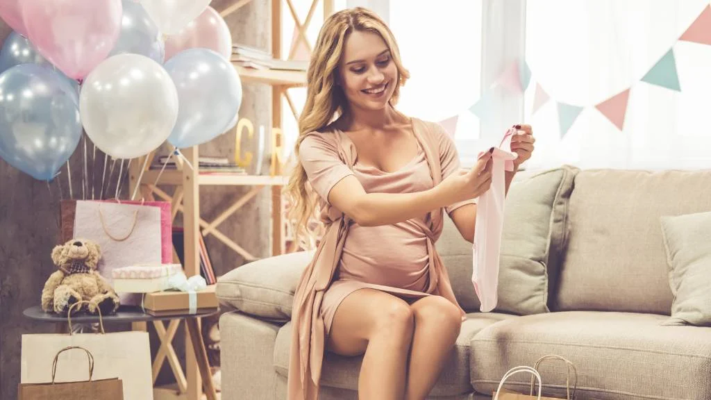 mom-to-be opening baby shower presents