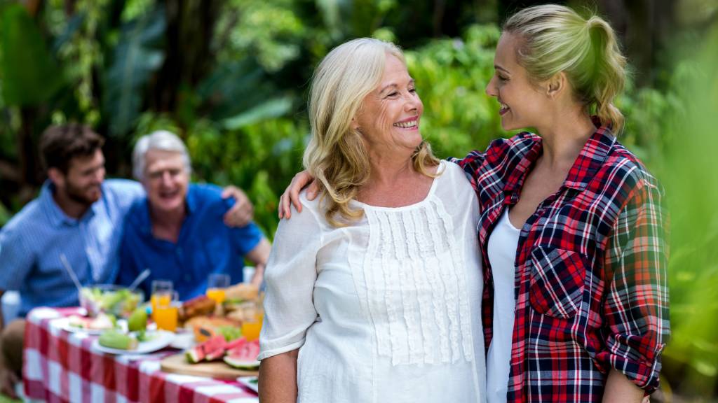 smiling mother and daughter-in-law at family picnic