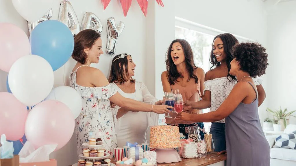 women toasting at indoor baby shower