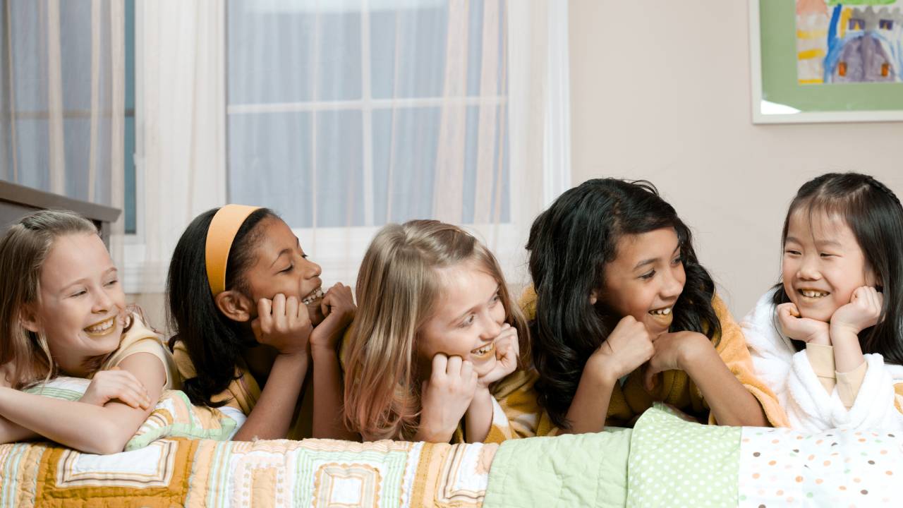 Friends laughing together at a sleepover