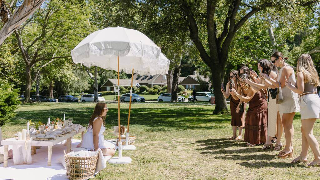 © Picnic Makers - https://picnicmakers.com/ group enjoying bridal shower game