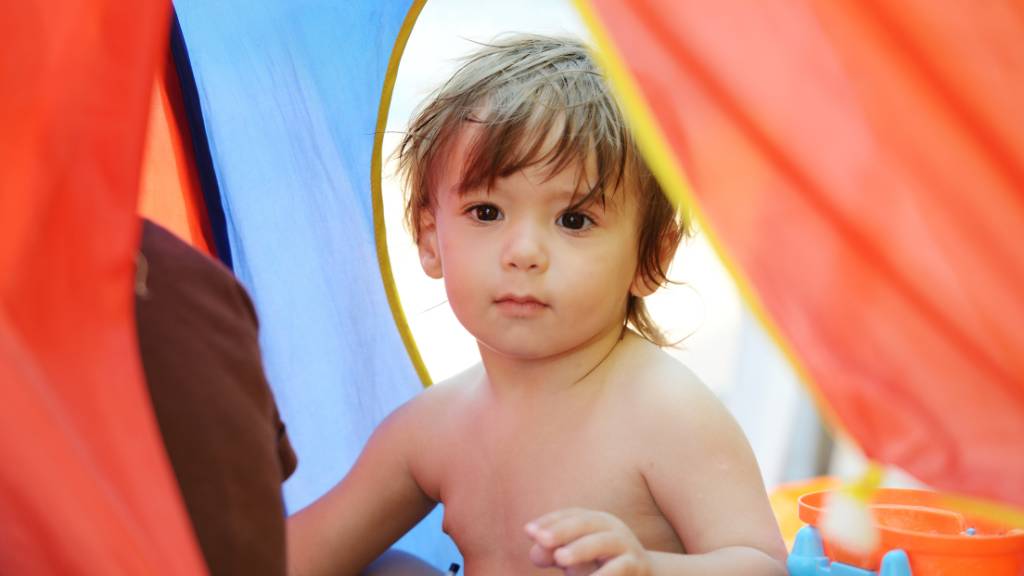 baby inside a beach tent