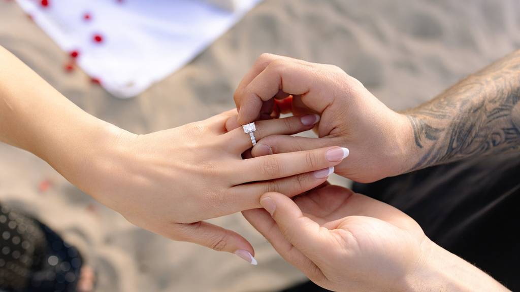 beach proposal ring moment