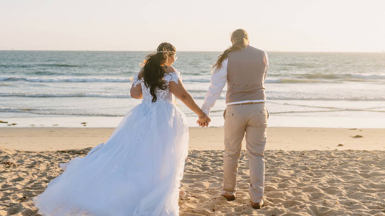 couple walking beach wedding