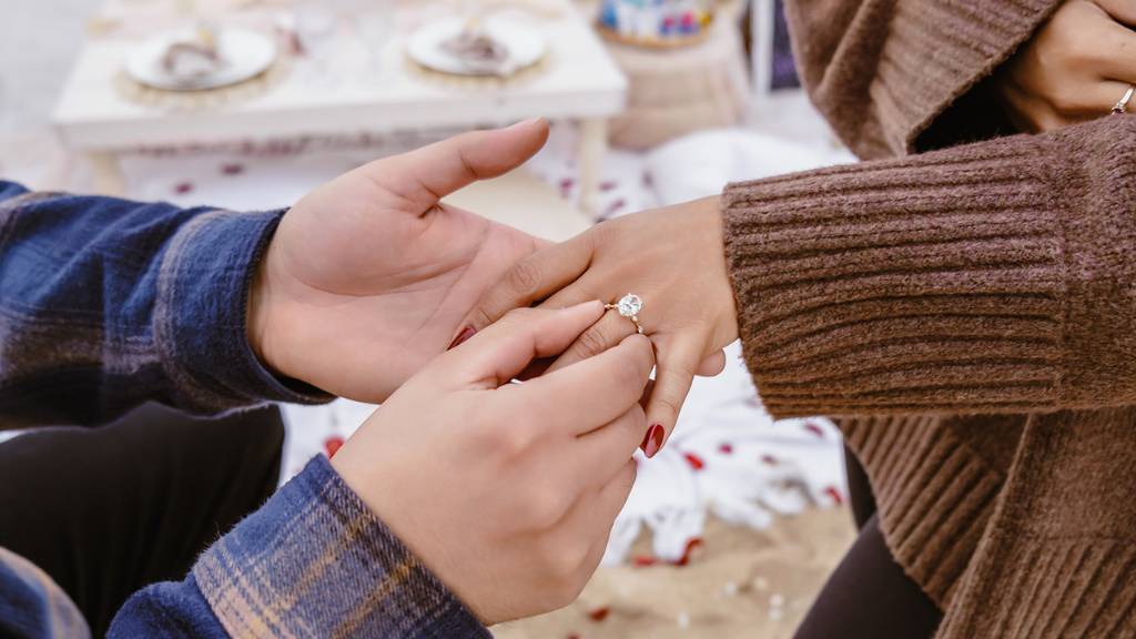 putting on engagement ring