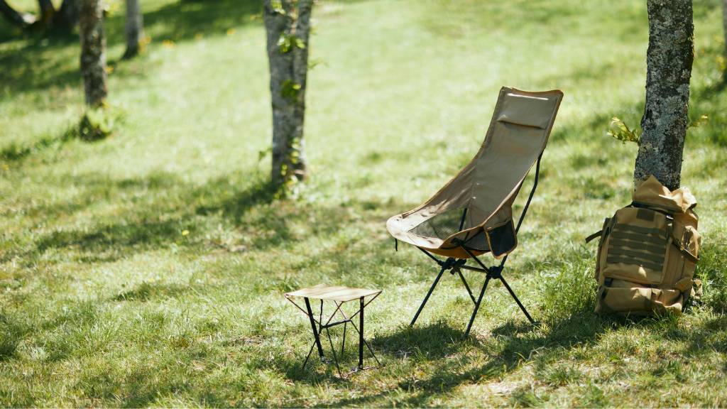 picnic backpack with camping chair under trees