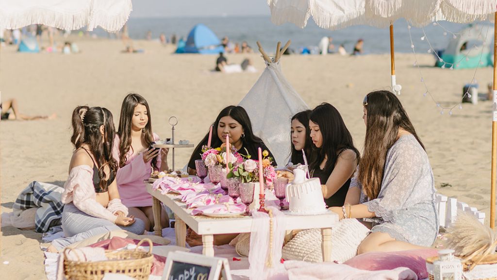 women celebrating baby shower picnic on the beach