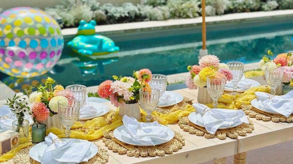 colorful baby shower table with flowers and plates