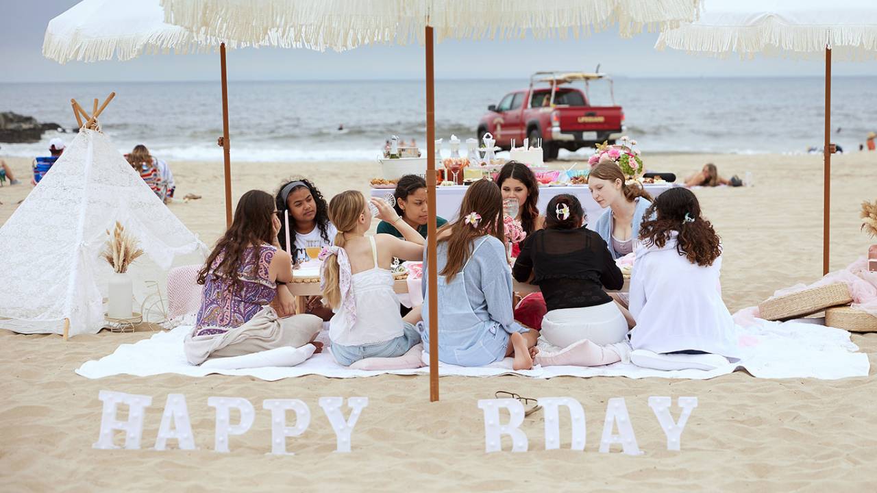 beach birthday picnic setup with friends