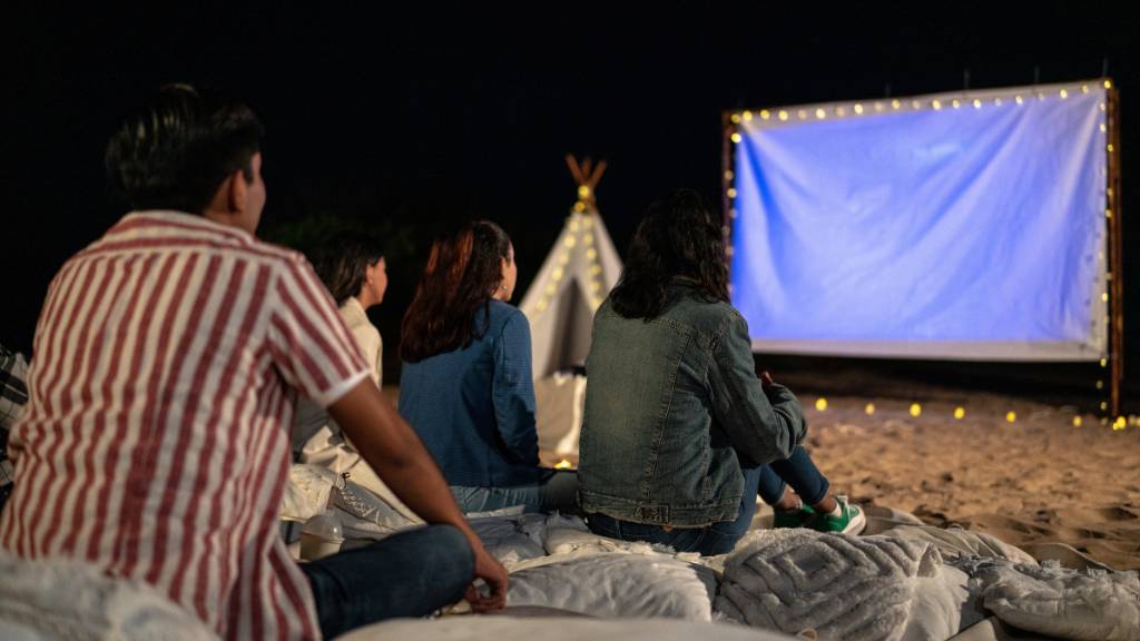Friends enjoying an outdoor movie night under the stars.