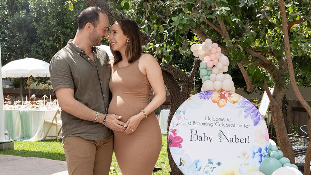 couple smiling at baby shower celebration
