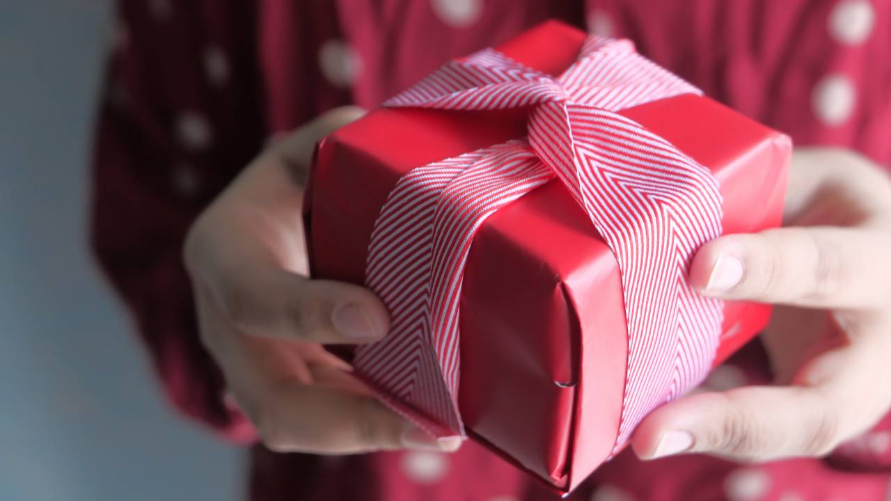 man holding a 1 year anniversary gift
