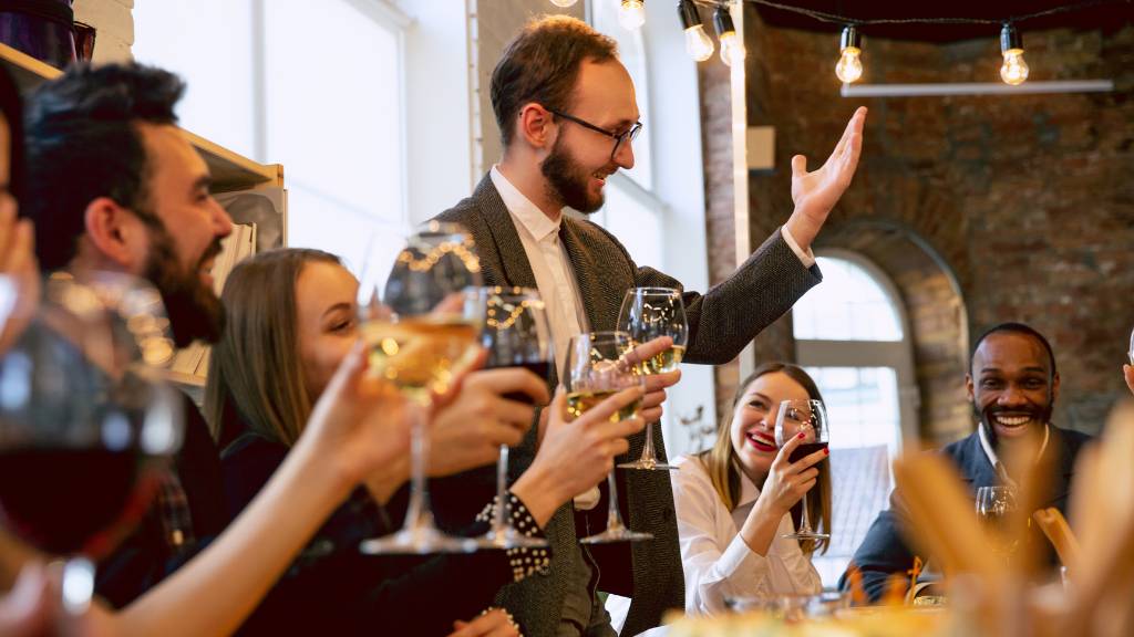 manager giving toast at office thanksgiving