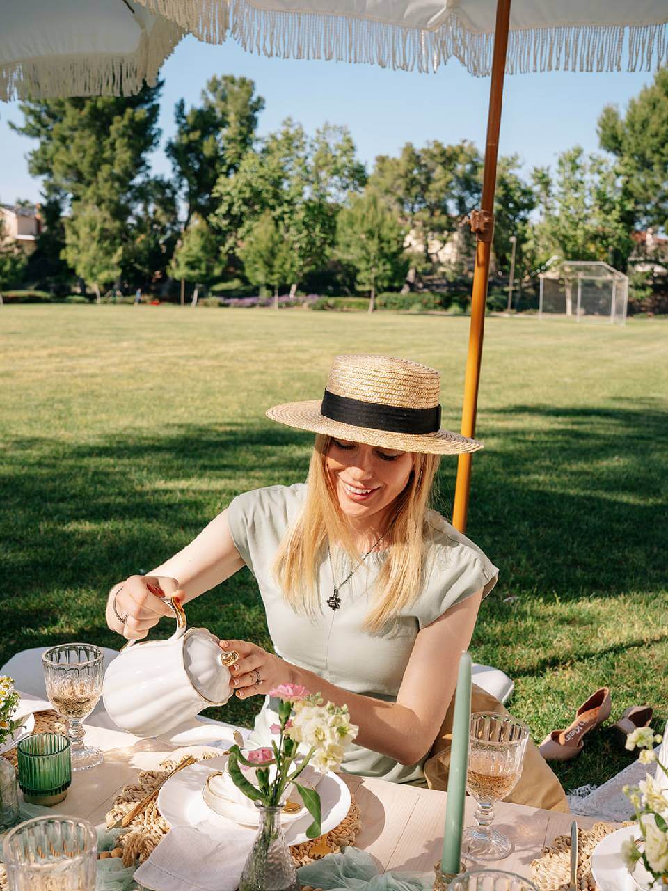 pouring tea into cute tea pots during a picnic