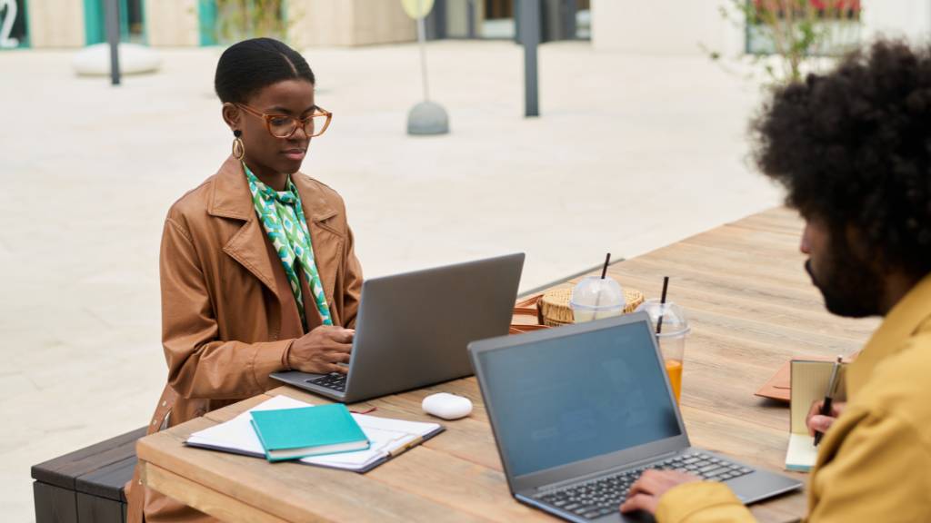 outdoor team meeting with laptops