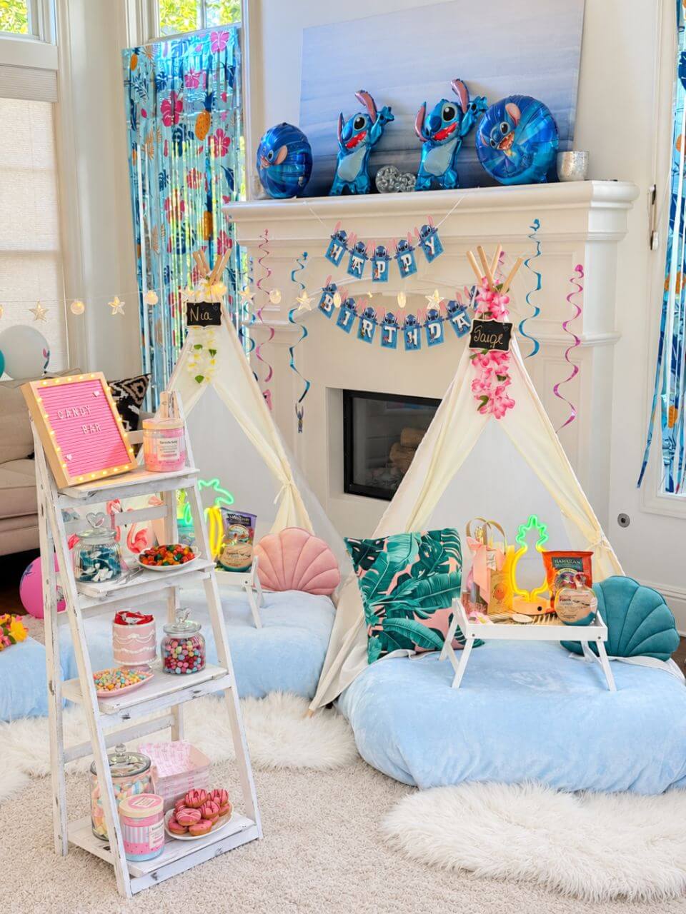 Stitch themed sleepover party setup with teepees, candy bar and personalized decor
